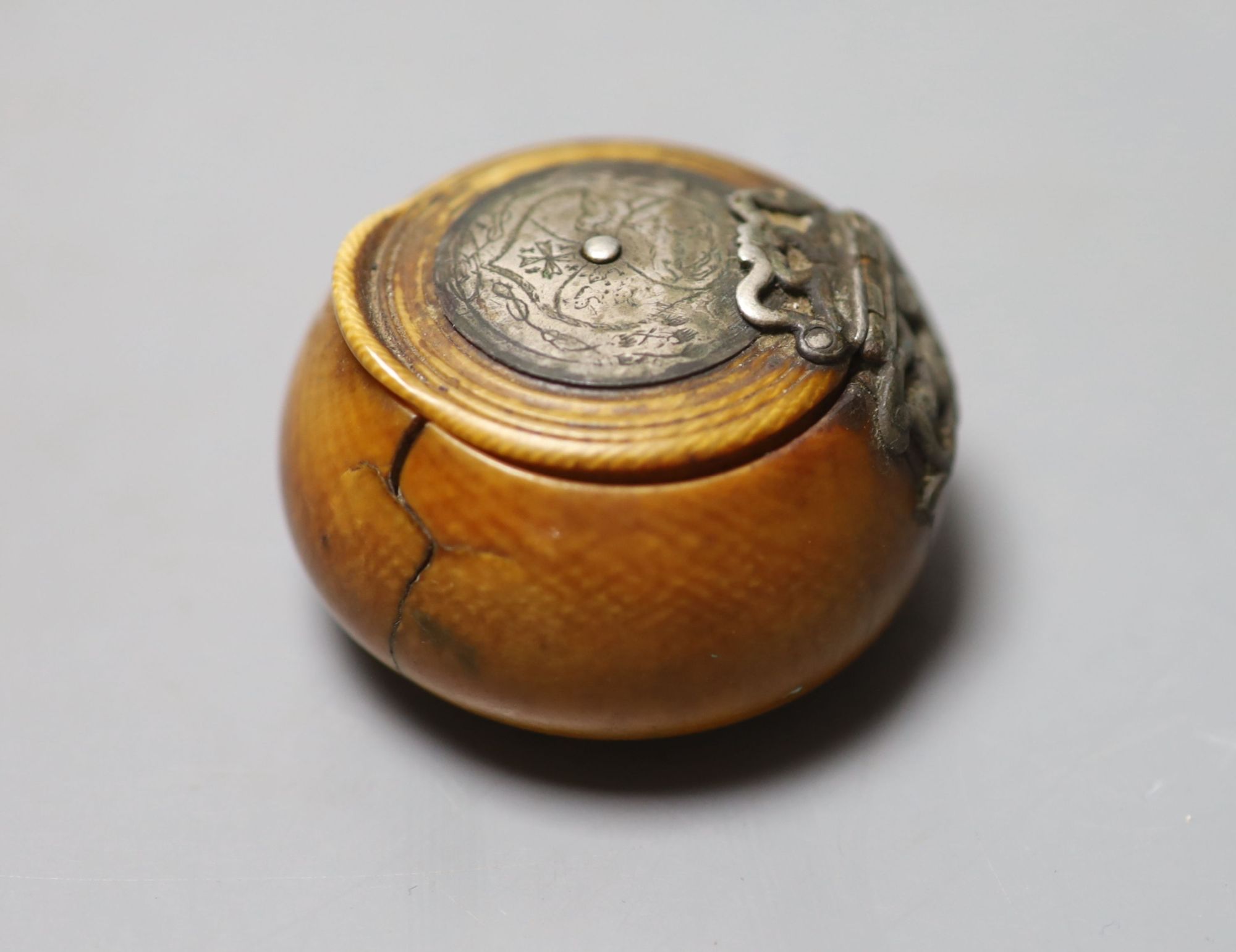 A 17th century French white metal mounted ivory snuff box, with pique work to inner lid, diameter 4.5cm